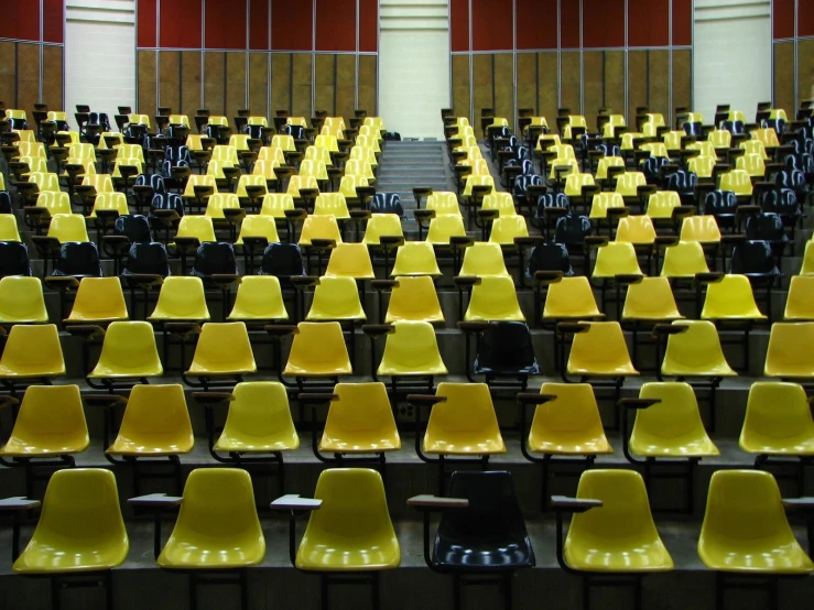 a row of yellow seats in a courtroom