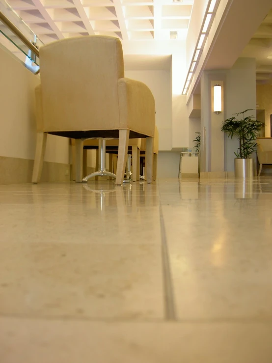 an office with two beige chairs, and a light fixture