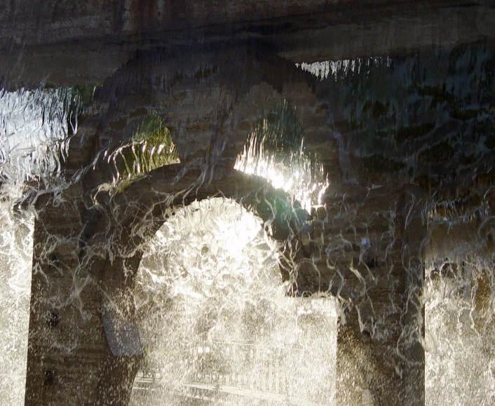 a large brick structure with many vines growing through it