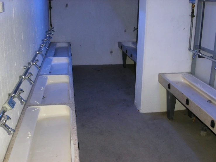 a row of sinks in a small bathroom