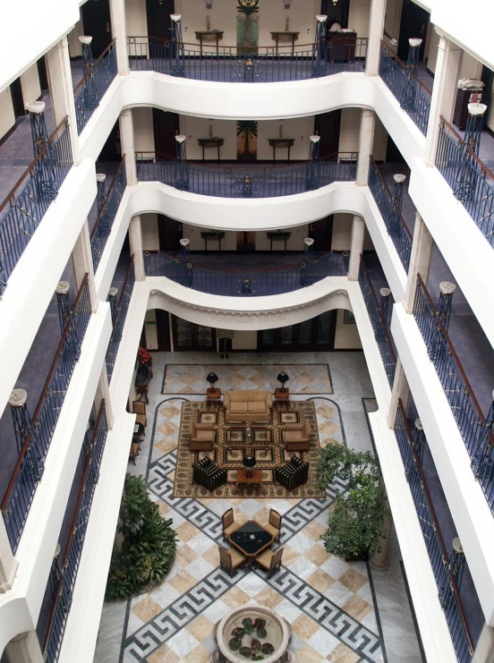 a large courtyard has lots of seating and a fountain