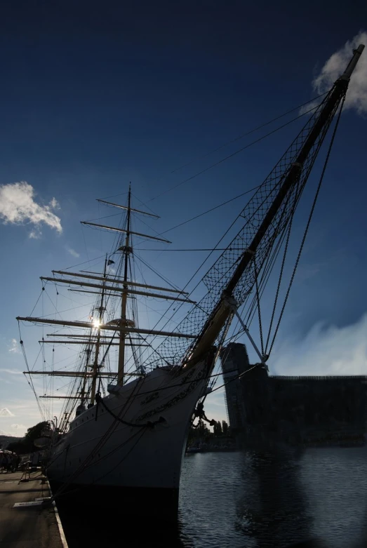 an old, sailing vessel moored in the water