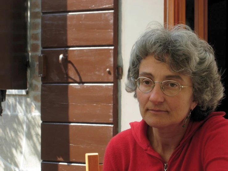 a women who is sitting in front of a door