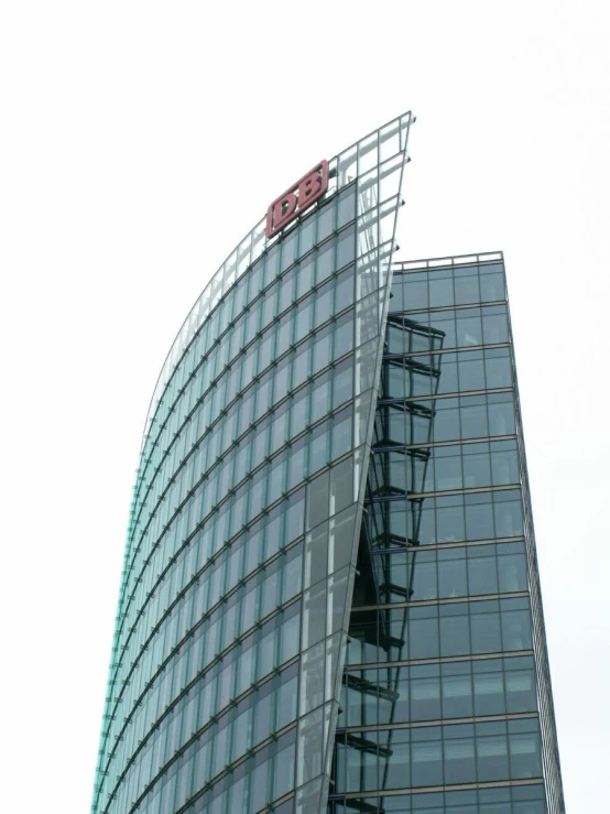 a big curved building with red letters on the side of it