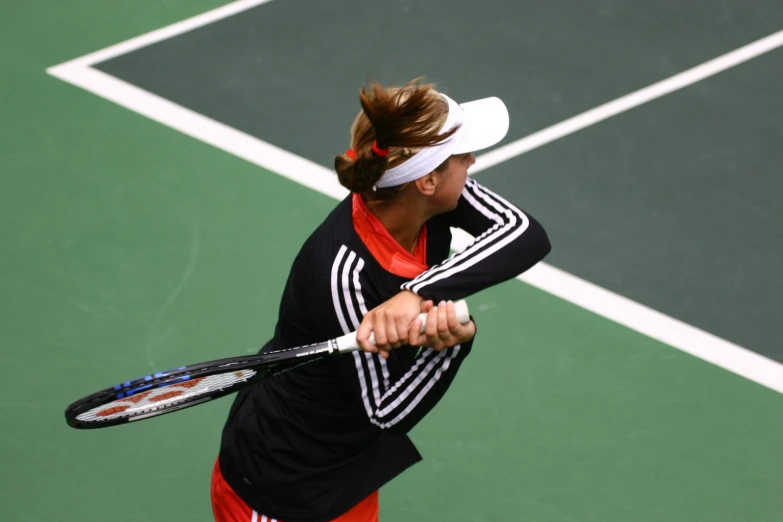 a woman on a court with a tennis racket