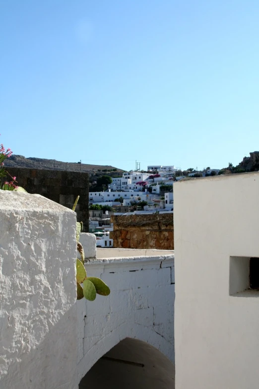 view from a cement wall with a white color building behind