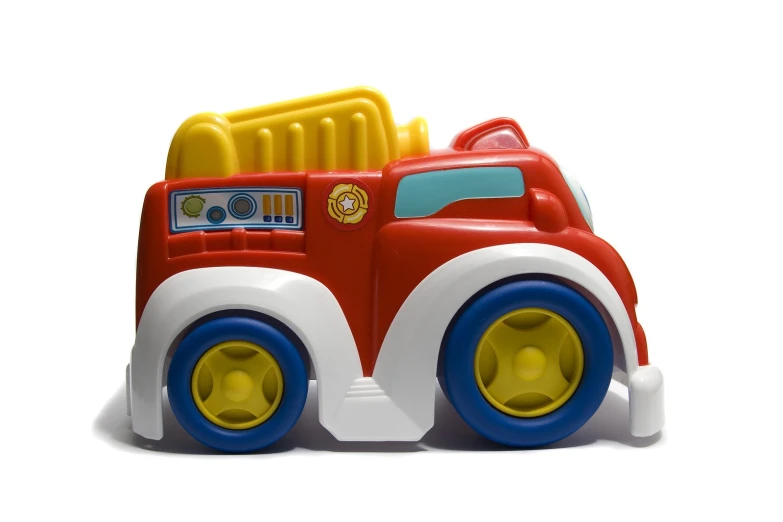 a small toy truck sitting on top of a white surface
