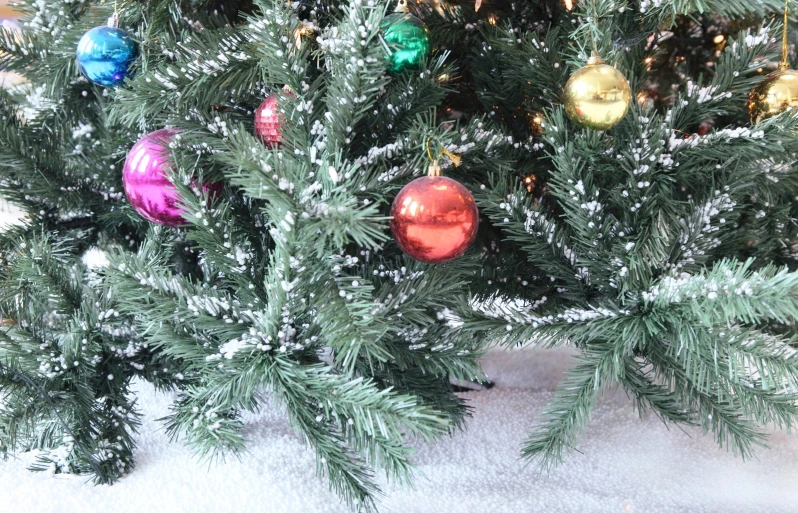 a small christmas tree with ornaments on top