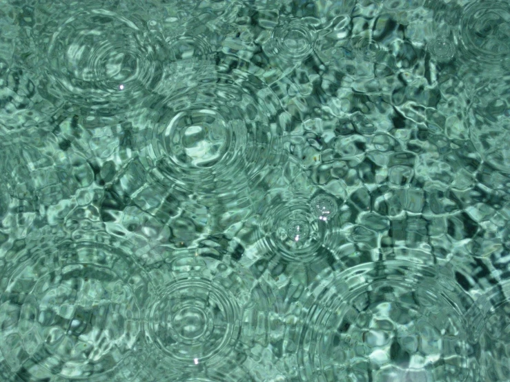 water that looks like a mosaic pattern in a pool