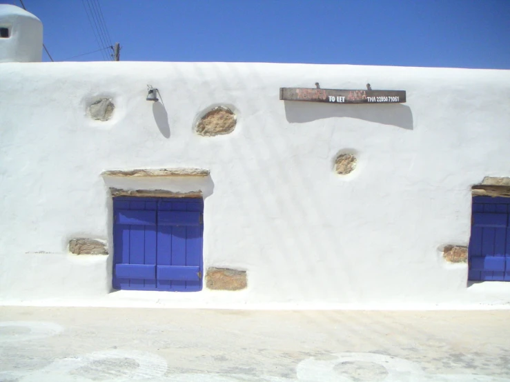 a white house with blue doors and windows