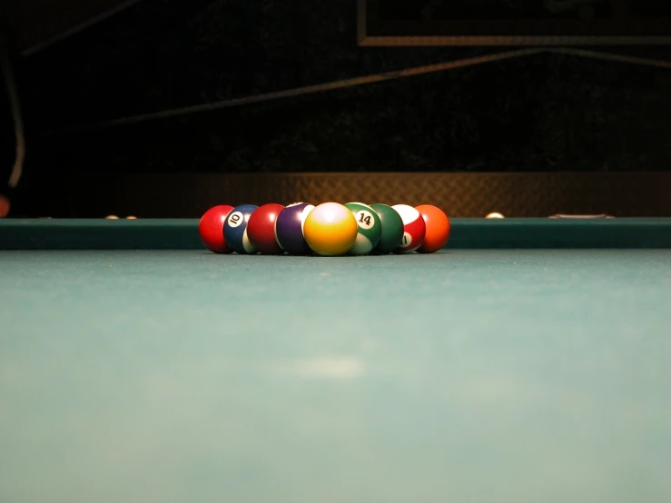 a group of eight ball pool balls laying on the table