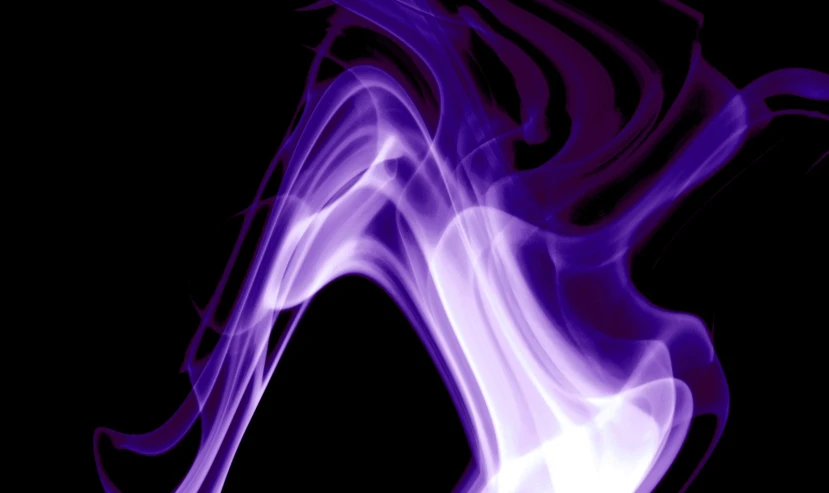a purple smoke swirls on top of black paper