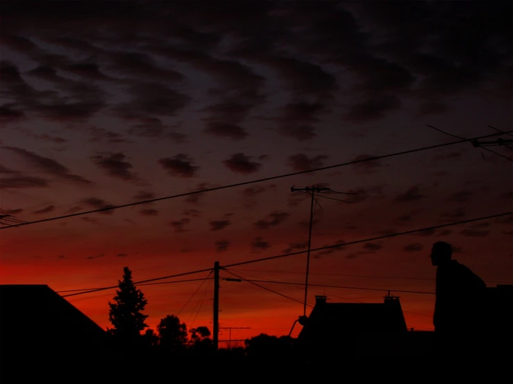 a view of the sun setting with the clouds and buildings