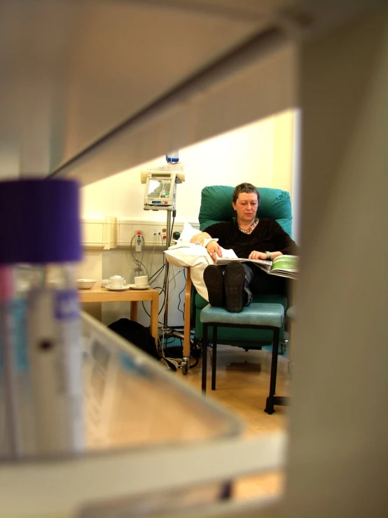 a man is sitting in a chair in an operating room