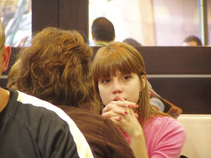 the girl looks bored as she sits on the bus