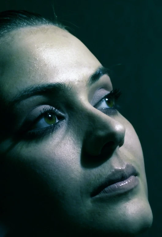 a close up s of a person's face in the dark