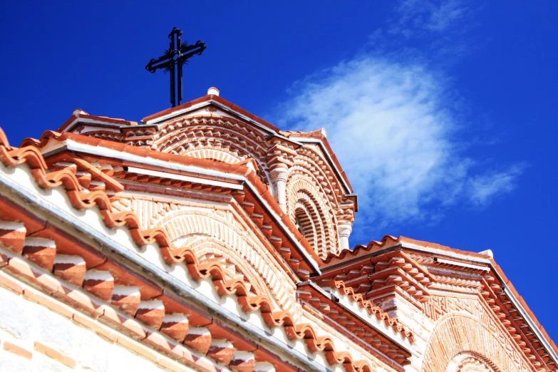 an ornate church steeple has a cross on top