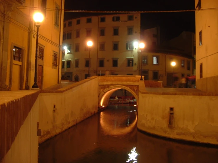 an image of a canal with lights by it