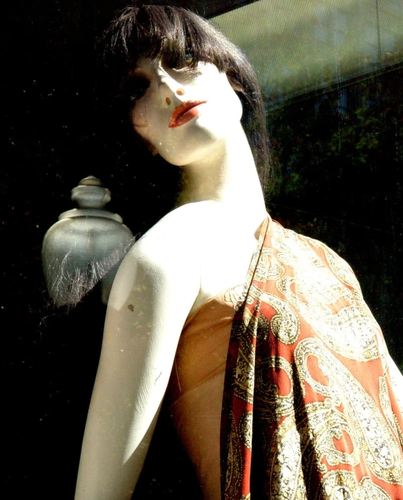 a female mannequin dressed in a red scarf