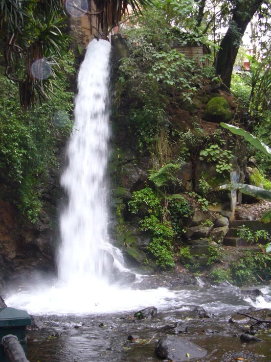 the waterfall cascades over a rocky hill