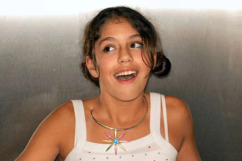 a smiling girl with a toothy grin and an airplane necklace