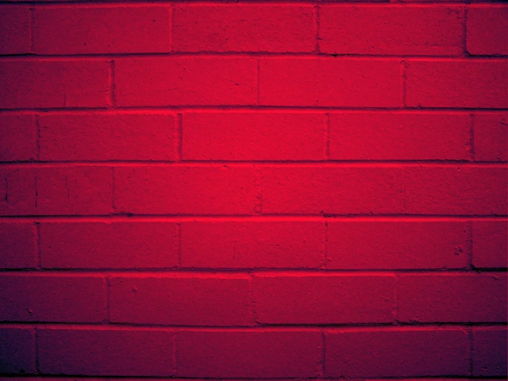 the red brick wall is painted bright red