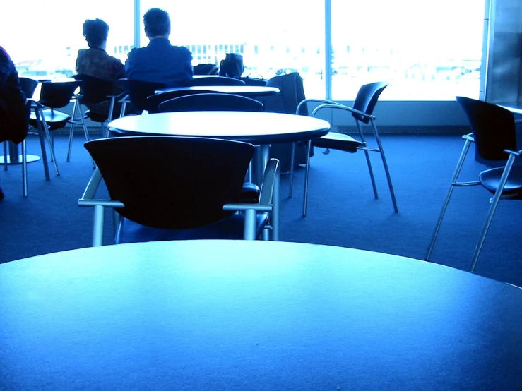 a person sitting at a table with a view of some people