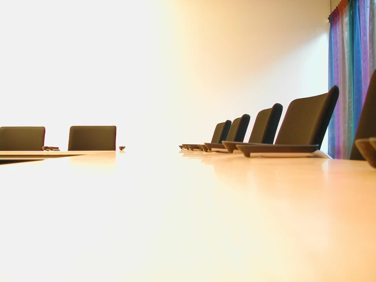 a room that has a white table and black chairs