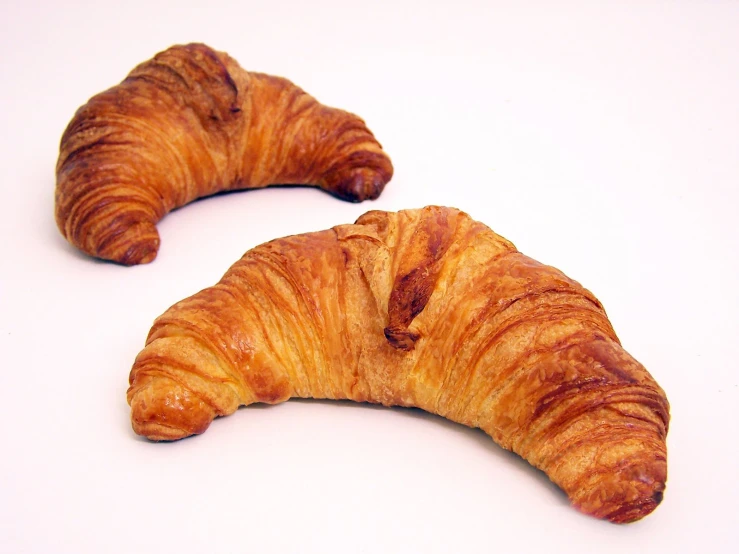 two large pastries are shown on a white surface