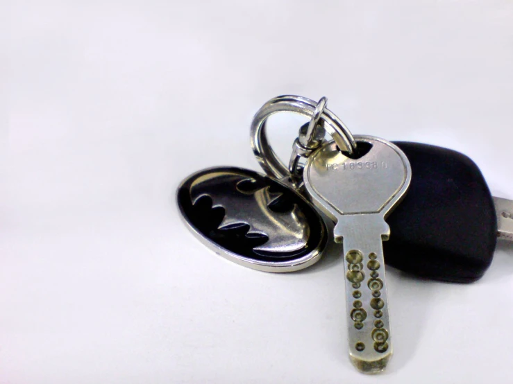 there is a key with a house on it and a car keychain