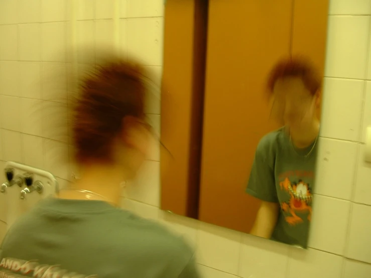 a person standing in front of a mirror taking a picture of themselves