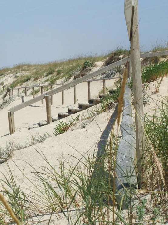 an old beach fence on a sandy beach