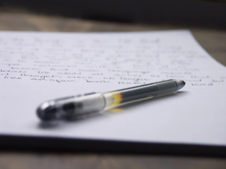 an image of a pen lying on top of paper