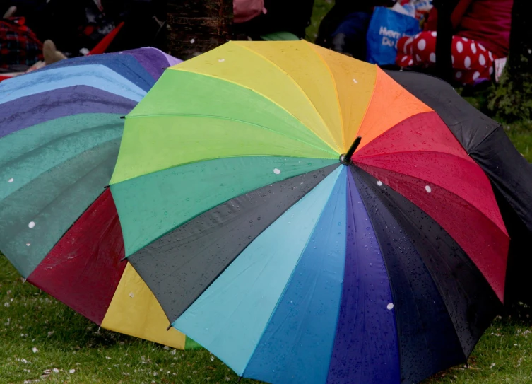 several colorful umbrellas that are in the grass