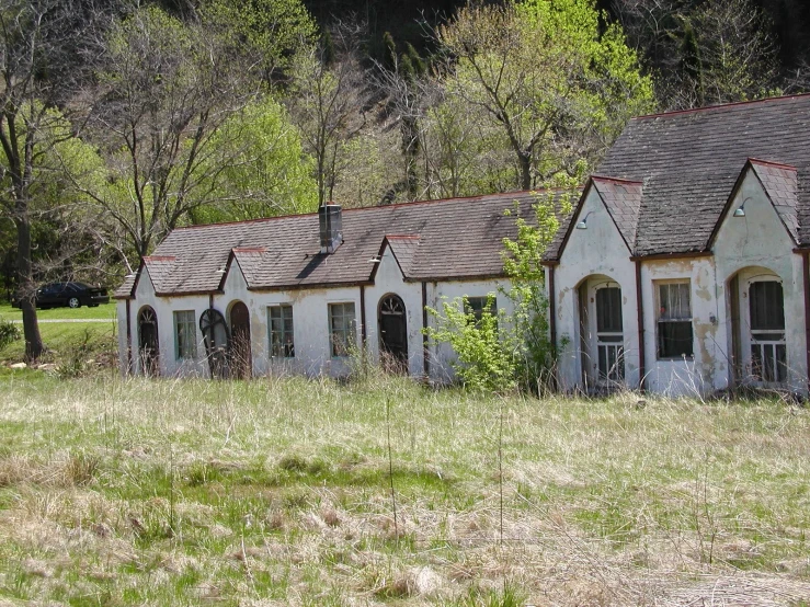 a row of small white buildings sitting in a field