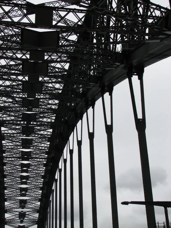 people are walking on the walkway of a bridge