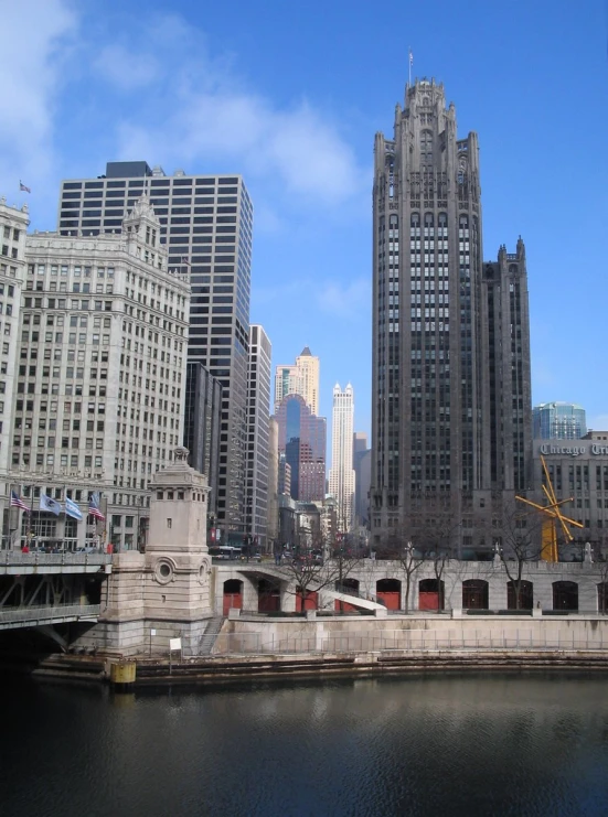 a very large river with some tall buildings in the background