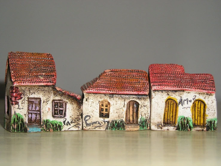 ceramic figurines of houses painted with graffiti
