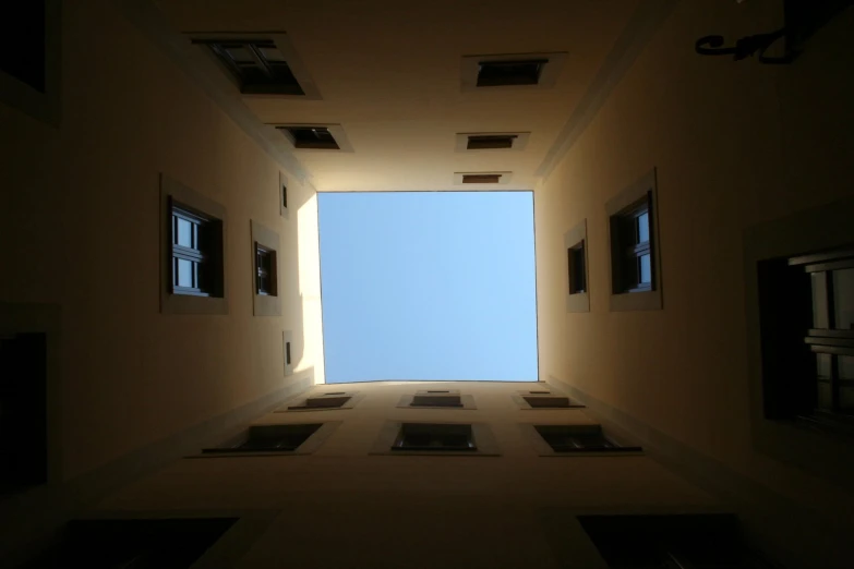 a hallway with a skylight and small window