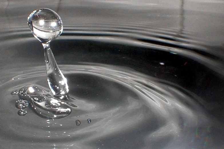 a close up of a sink with water and drops