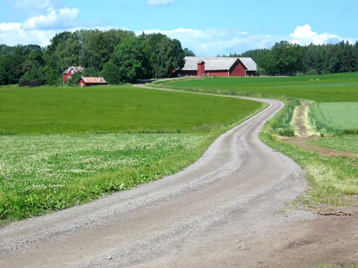 the house on the farm looks as though it is a red truck