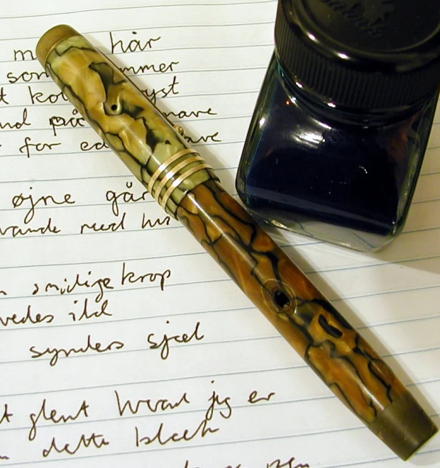 a pen resting on top of a handwritten note