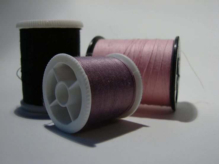 two spools of thread sit on a table