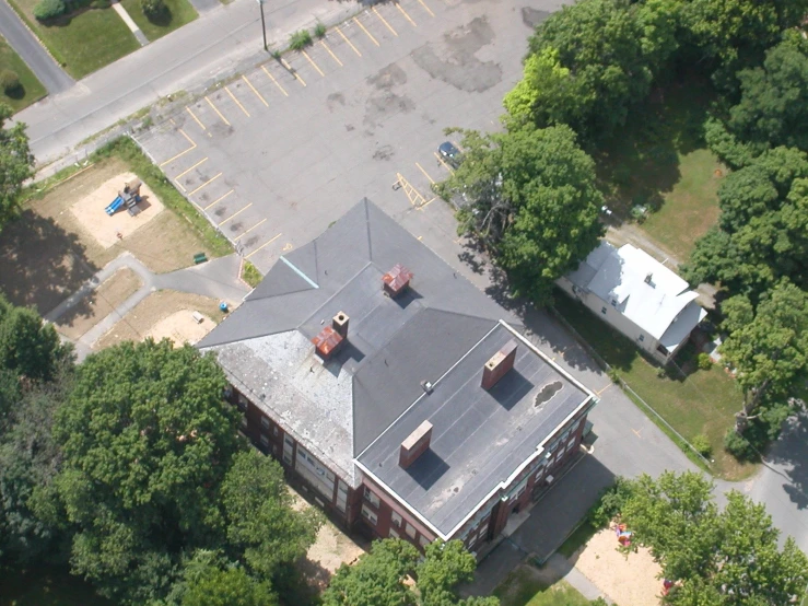 an aerial view of two buildings with a large tarp