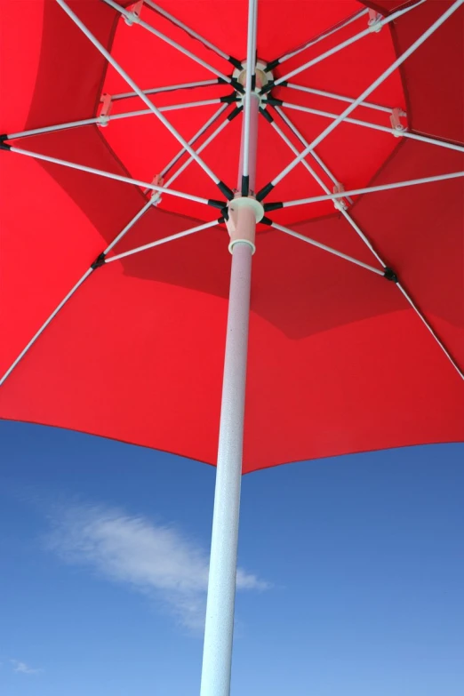 an umbrella is being used as a table on the beach