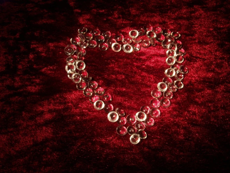 a silver celet on a red velvet background