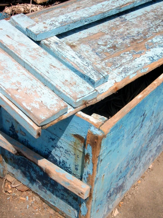 a blue wood cabinet with two open doors on the outside