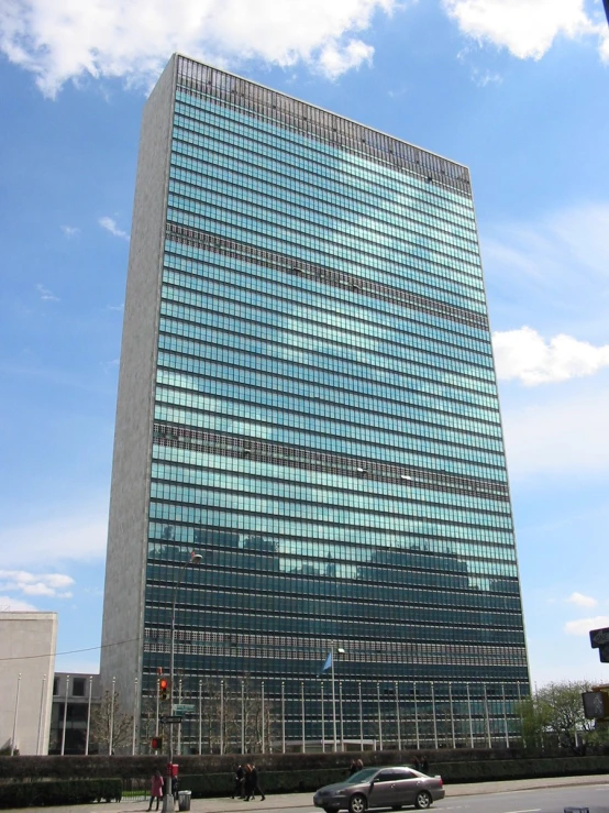 a tall building with a few glass windows next to it