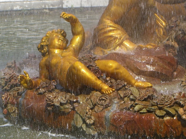 a statue of a woman laying on a rock
