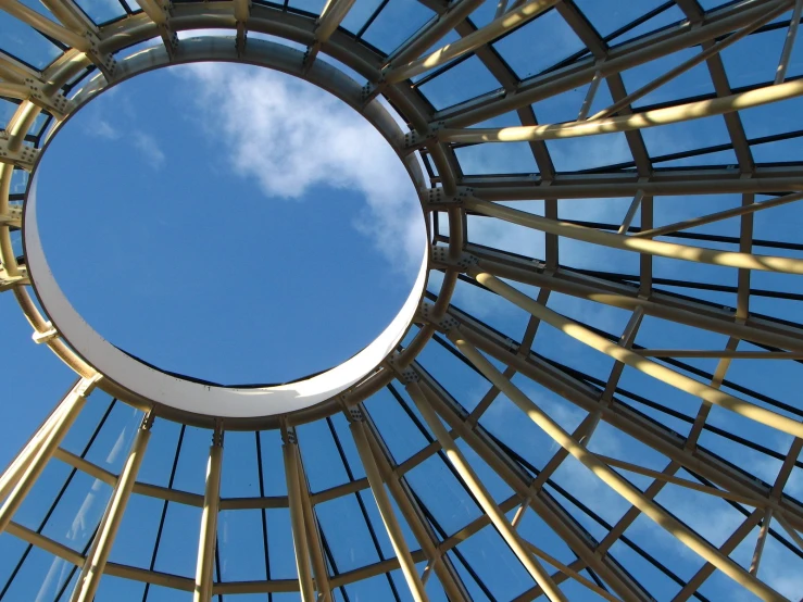 a view looking up at the sky through a pergolia